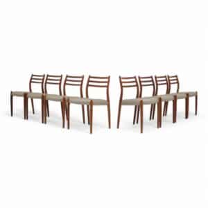 Vintage set of 8 Teak Dining Chairs Model 78 by Niels Otto Moller white background.