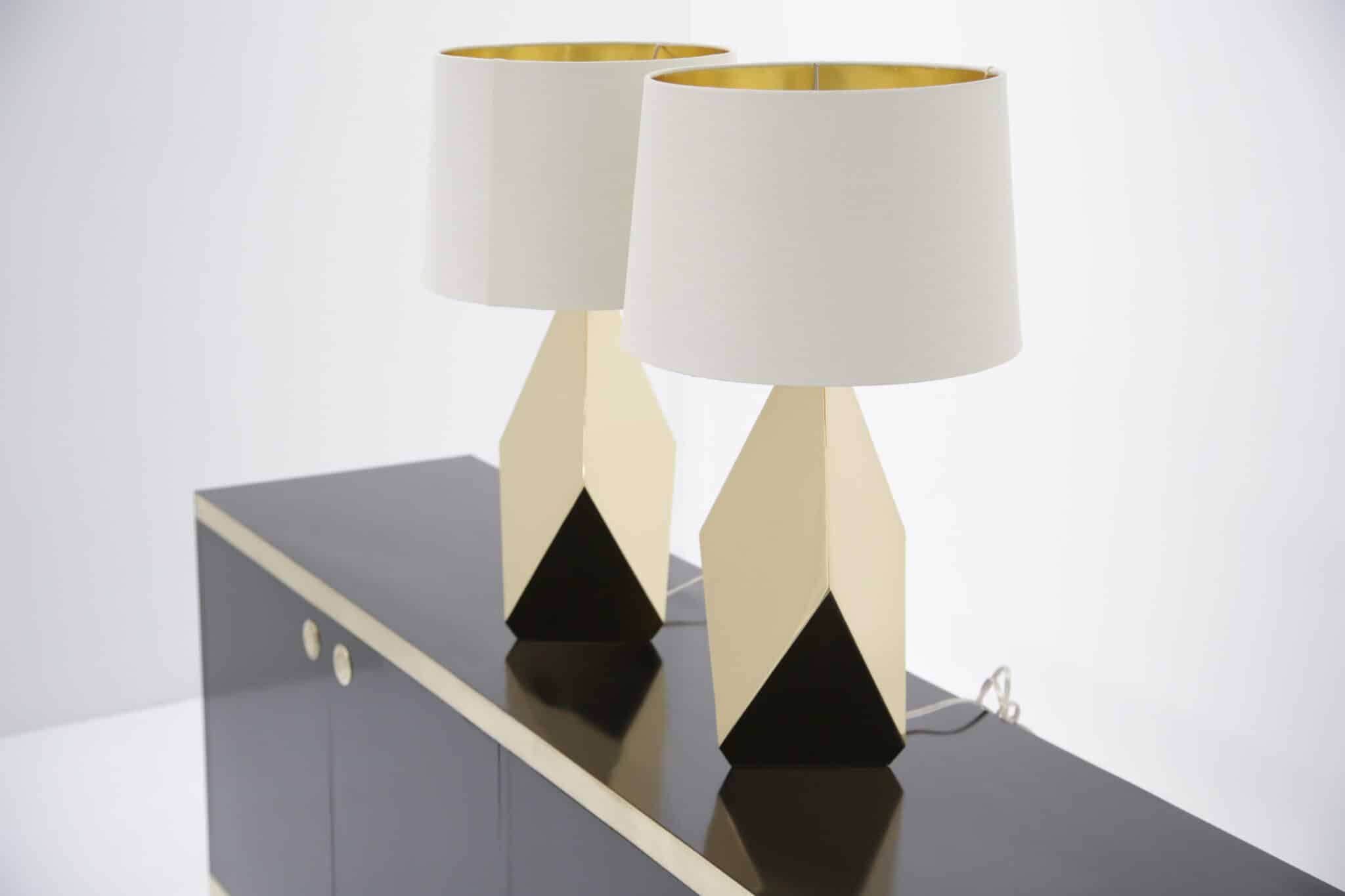 Pair of faceted brass American mid-century lamps on black sideboard