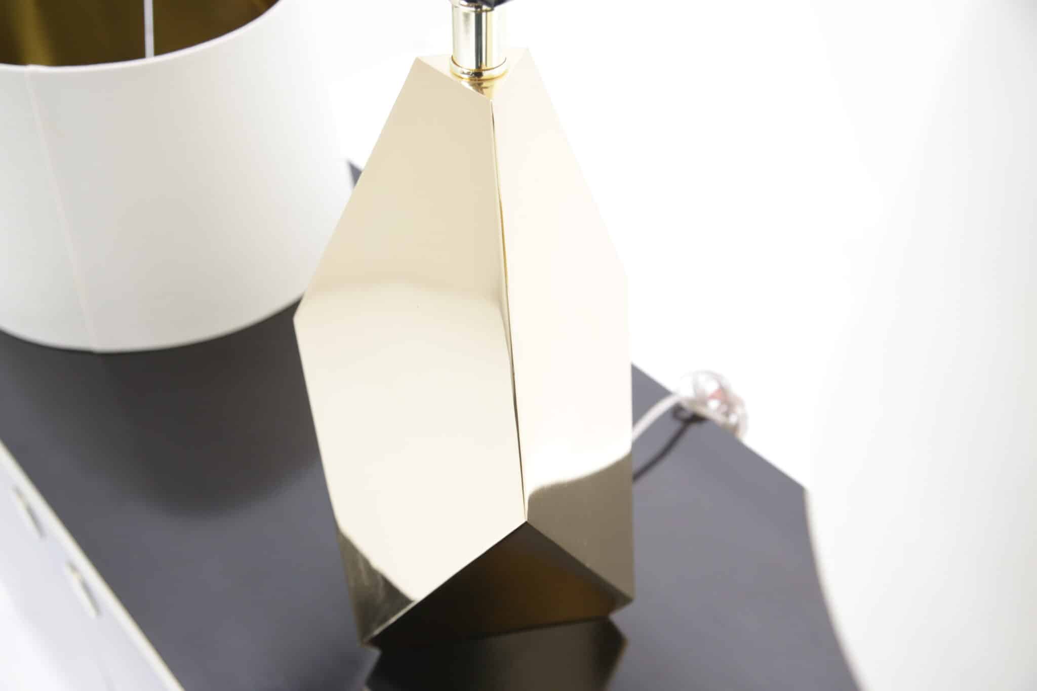 Pair of faceted brass American mid-century lamps on black sideboard