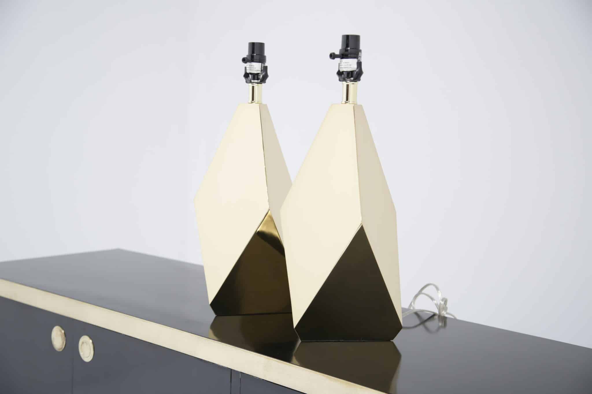 Pair of faceted brass American mid-century lamps on black sideboard