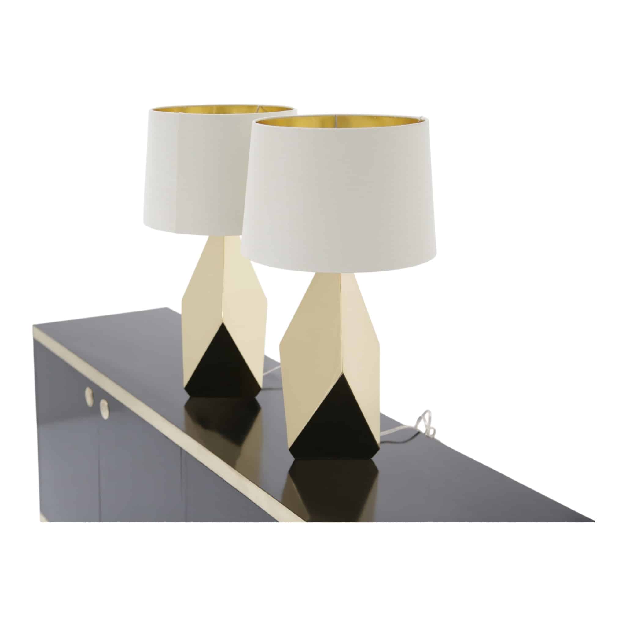 Pair of faceted brass American mid-century lamps on black sideboard
